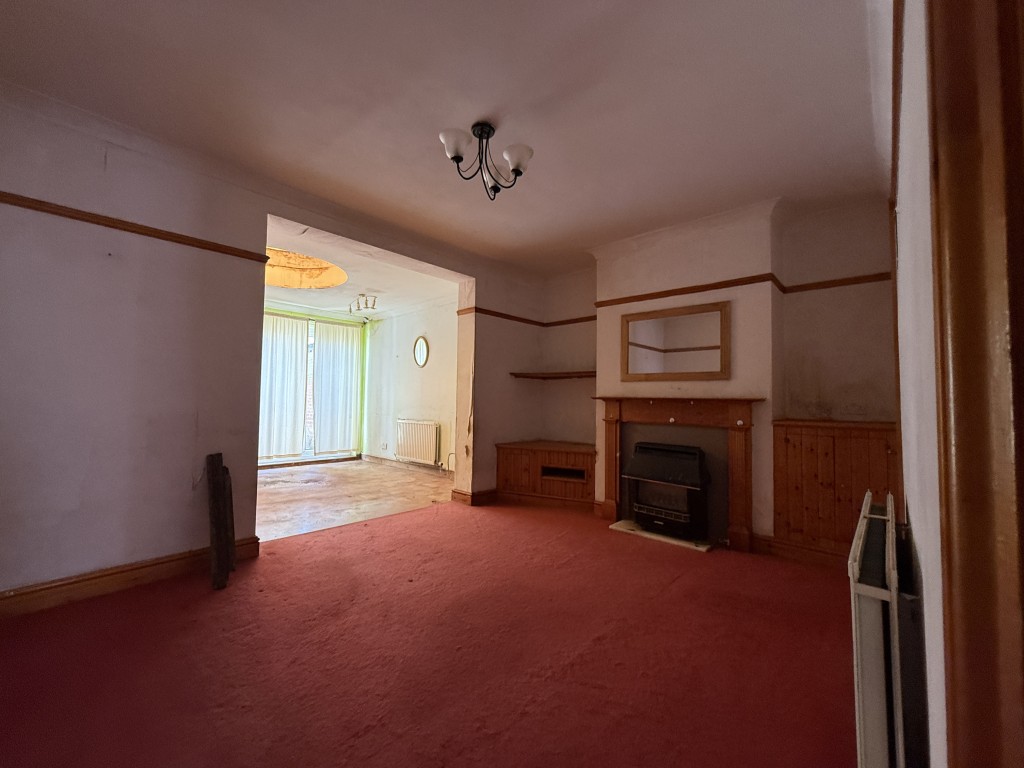 Lot: 93 - TWO-BEDROOM HOUSE REQUIRING IMPROVEMENT CLOSE TO TOWN CENTRE - Living room and kitchen/dining area